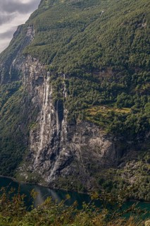 The dramatic Seven Sisters waterfall plunges into the Gairangerfjord in Norway Europe, surrounded