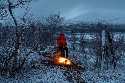 Man at the campfire, Stora Sjöfallet National Park, World Heritage Laponia, Norrbotten, Lapland,