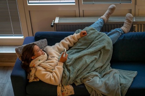 Symbolic image energy saving, cold winter, energy crisis, cold flat, mother and daughter lying on