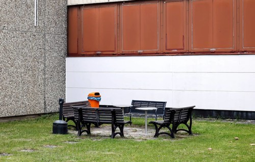 Benches, a table and a wastepaper basket in an outdoor break area on a factory site, Berlin,