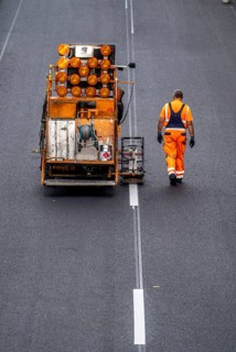 Marking work after the application of new whisper asphalt surface for the A40 motorway, in the