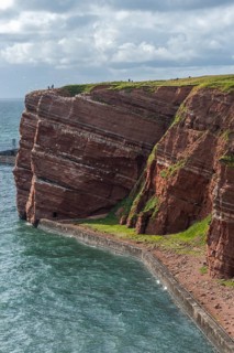 Red coloured sandstone, steep cliff coast of the offshore island of Heligoland, home of the