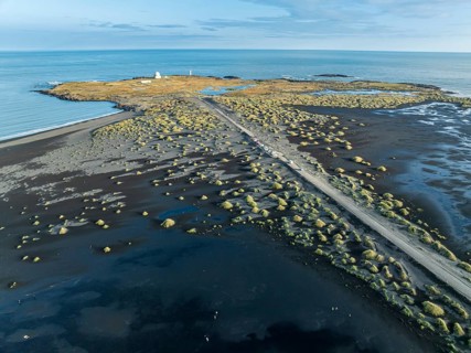 Aerial view of black lava beach, lighthouse and NATO radar station, Stokksnes, east of Höfn, East