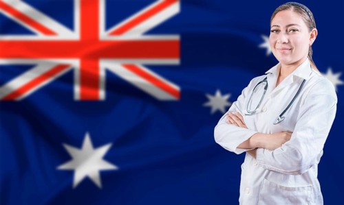 Female doctor on Australia flag. Doctor with crossed arms on Australian flag. Australian Health and