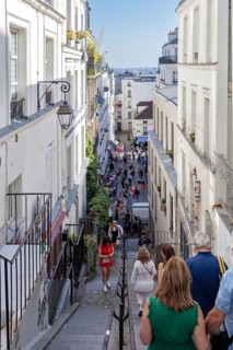 People descend a staircase and enjoy the urban view, Paris