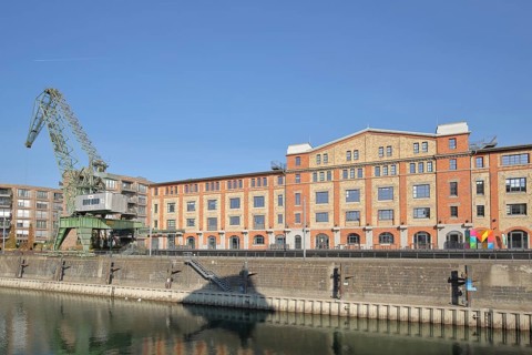 Old wine warehouse with harbour crane, quay, quay wall, gantry crane, container crane, shipyard