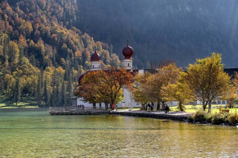 Pilgrimage church St. Bartholomä in autumn at Königssee, autumnal mountain landscape at the lake,