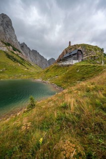 Wolayersee and Alpine Club hut Wolayerseehütte, rocky cloudy mountains, Carnic Alps, Carnic High
