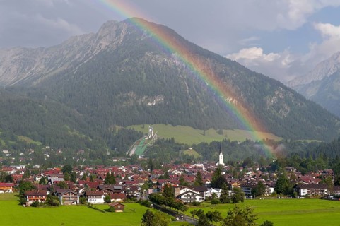 View over Oberstdorf with rainbow, behind it the Schattenberg, 1845m, Oberallgäu, Bavaria, Germany,