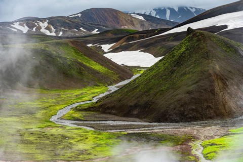 Colourful volcanic landscape with hills and snow, volcanic steaming hot springs, Laugavegur