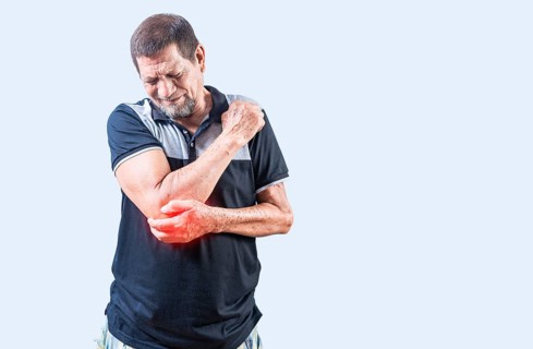 Elderly man suffering from elbow pain. Concept of Elbow Arthritis. Mature man with elbow pain