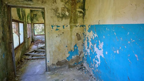 Dilapidated blue walls and windows in an abandoned building showing signs of decay, Lost Place,