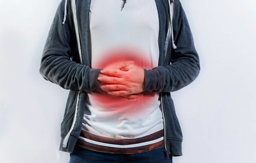 Person with digestive and stomach problems isolated. Unhappy man with digestive problems isolated