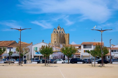 Market square with parked cars in summer, Saintes-Maries-de-la-Mer, Camargue, France, Europe