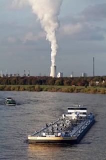 Barge on the Rhine near Duisburg-Laar, column of smoke above the cooling tower of the Thyssenkrupp