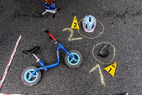 Markings at an accident scene with a balance bike for children, helmet, reenacted accident