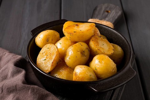 Fresh Cooked, new potatoes, with dill, on a wooden table, selective focus. close-up, toning, no