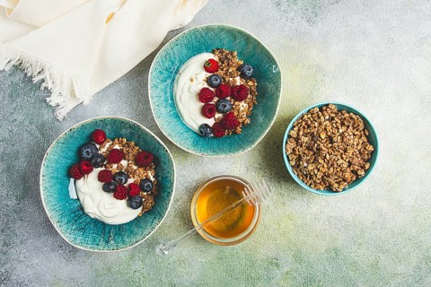Breakfast, two bowls, yogurt, muesli with berries, and honey, homemade, no people