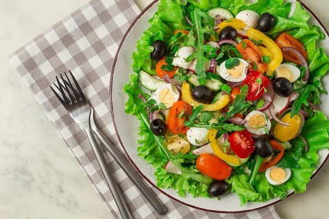 Vegetable salad, with quail eggs and olives, fresh, close-up, no people