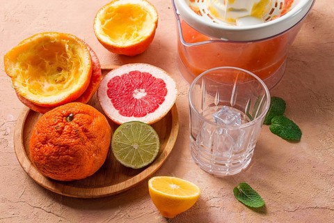 Citrus juicer, sliced fruit, glass with ice, close-up, no people, breakfast