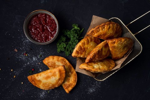 Fried mini pasties, with red sauce, top view, close-up, no people, selective focus