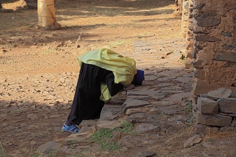 Amhara region, Gondar, Gonder, Moench prays in front of the Debre Berhan Selassie church, Ethiopia,