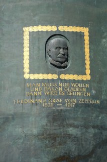 Zeppelin monument with head relief and quote, You only have to want and believe in it then it will