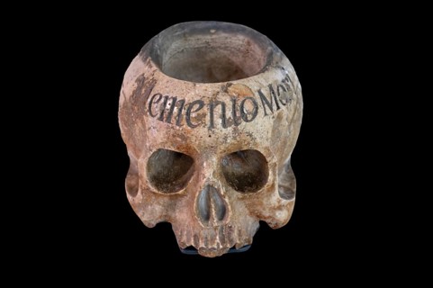 Holy water vessel in the shape of a skull, marble, 17th century, on a black background,