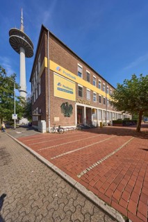 Deutsche Post AG, post office at Berliner-Tor-Platz and television tower against blue sky with