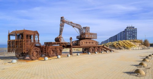 Caterpillar + Flatbed Trailer, artwork by Belgian neo-conceptual artist Wim Delvoye at seaside