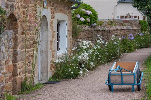 Typical alley, path on the Ile de Brehat, handcart as a transport aid on the car-free island, Ile