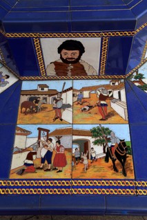 Ceramic tiles on street furniture seat scenes from Cervantes Don Quixote story, Algeciras, Spain,