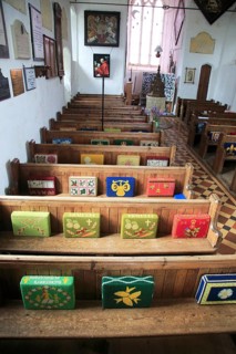 Knitted kneelers on pews, Church of Saint Gregory, Hemingstone, Suffolk, England, UK