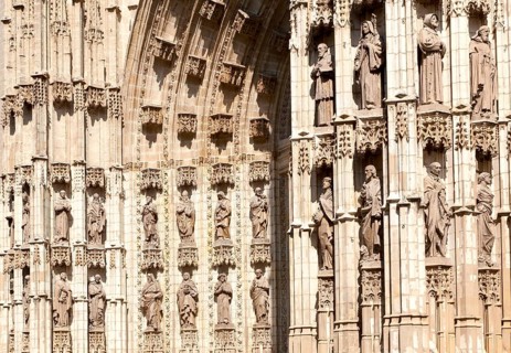 Detail of carved stonework of cathedral frontage showing statues of saints, Seville, Spain, Europe