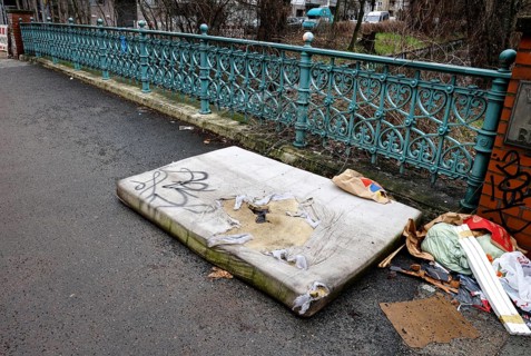 A mattress lying on a pavement, illegal waste disposal in the Berlin district of Wedding,