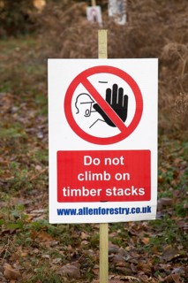 Forestry tree felling signs on Upper Hollesley Common, Suffolk, England, UK, Do not climb on timber