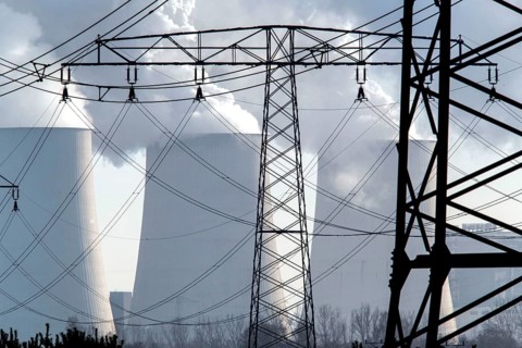 Steam rises from the cooling towers of the Vattenfall power plant in Jänschwalde, power lines and