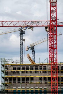 Construction cranes on two large construction sites, construction of office buildings in
