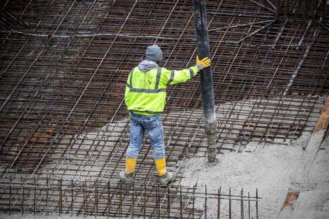 Construction site, concreting, the foundation of a building is concreted, the concrete is pumped