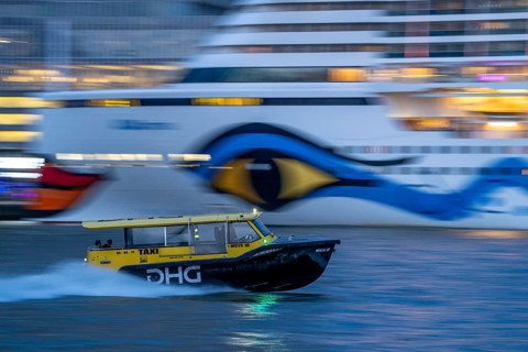 Cruise ship Aida Prima at the Cruise Terminal of Rotterdam, Kop van Zuid, skyscrapers at the