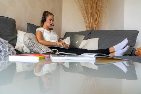 Young student learns at home, online, in conversation with other students