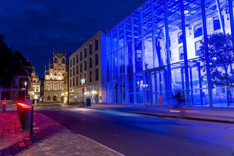 Historic old town, facade of the historic town hall, blue illuminated building of the Münster
