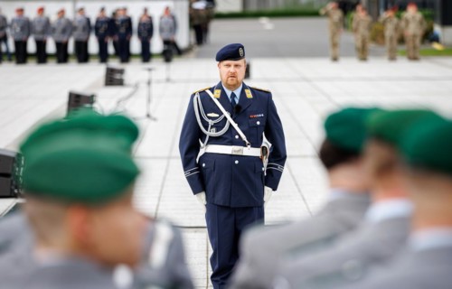 An air force soldier of the guard battalion gives commands to army soldiers of an honour formation