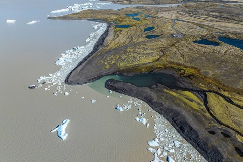 Aerial view over the glacial lake Fjallsárlón, glacier Fjallsjökull, part of Vatnajökull glacier,