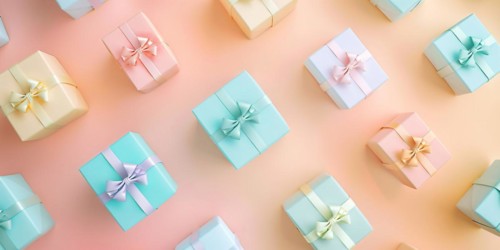 Small gift boxes on pastel orange and yellow background, KI generiert, generiert, AI generated