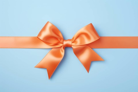 Orange tied silk ribbon on blue background. KI generiert, generiert, AI generated