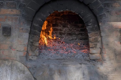 Firing up a traditional bread oven, Münsterland, North Rhine-Westphalia, Germany, Europe