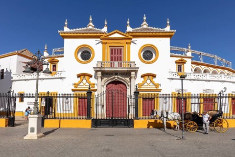 Facade of the Spanish-style bullring with carriage in the foreground, Seville