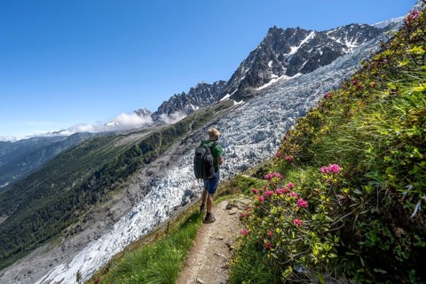 Hiking on the trail to La Jonction, Glacier des Bossons, behind the summit of the Aiguille du Midi,
