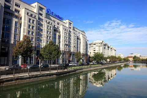 Apartment blocks and office buildings, bank building on the Dambovita River, Bucharest, Romania,